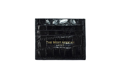Black crocodile skin wallet with 'The West African' branding on a white background
