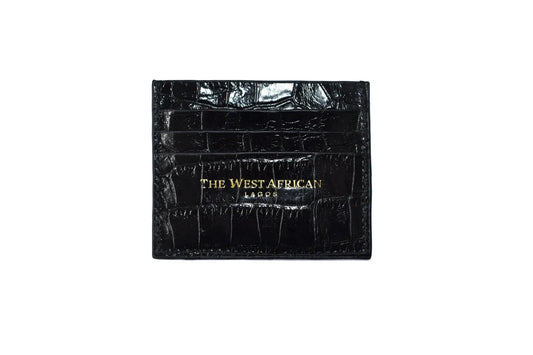 Black crocodile skin wallet with 'The West African' branding on a white background