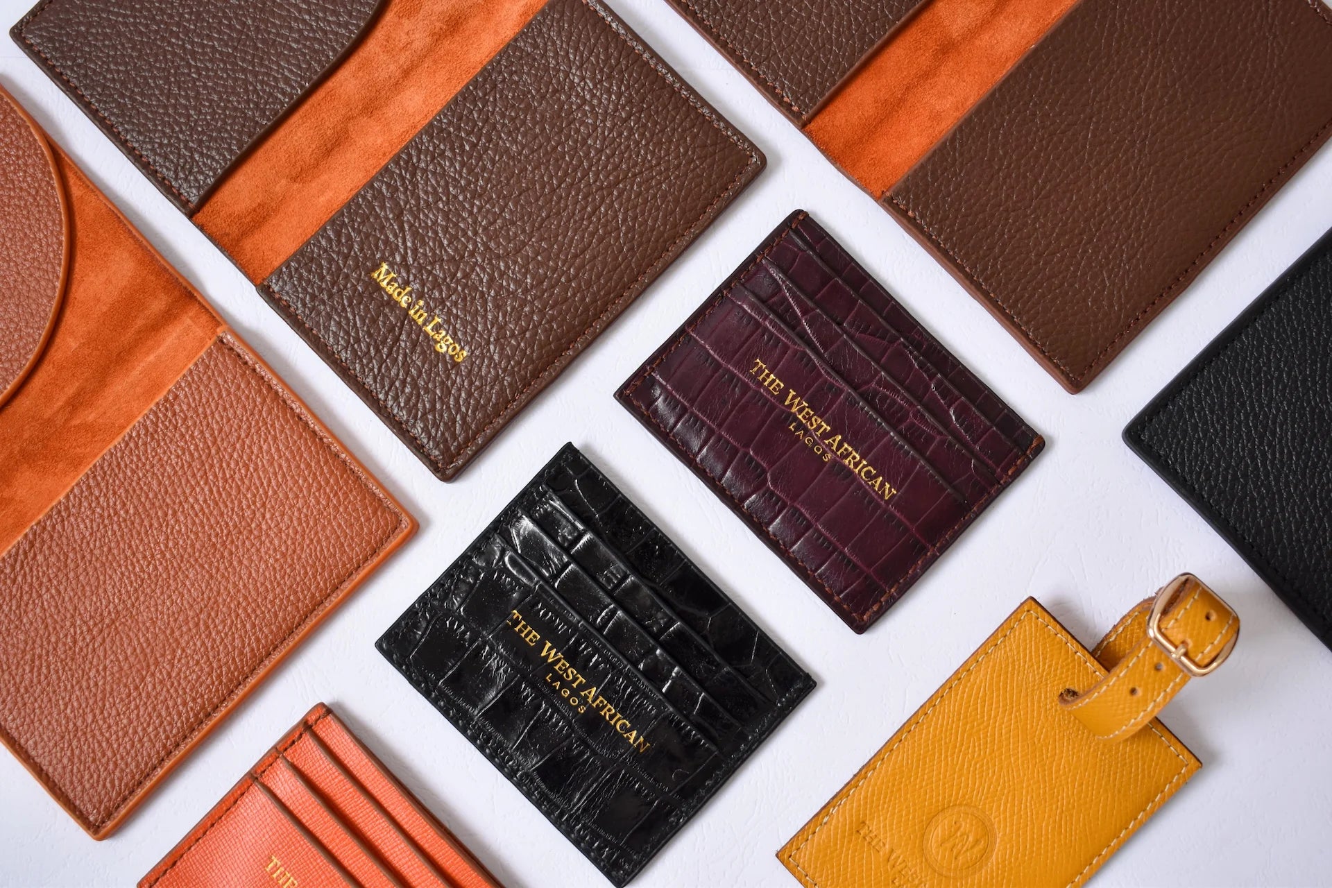 Collection of leather luggage tags in various colors on a white background