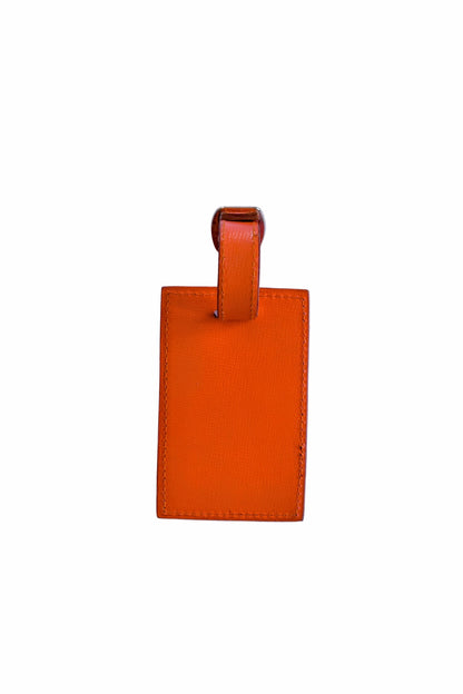 Orange leather luggage tag on a white background