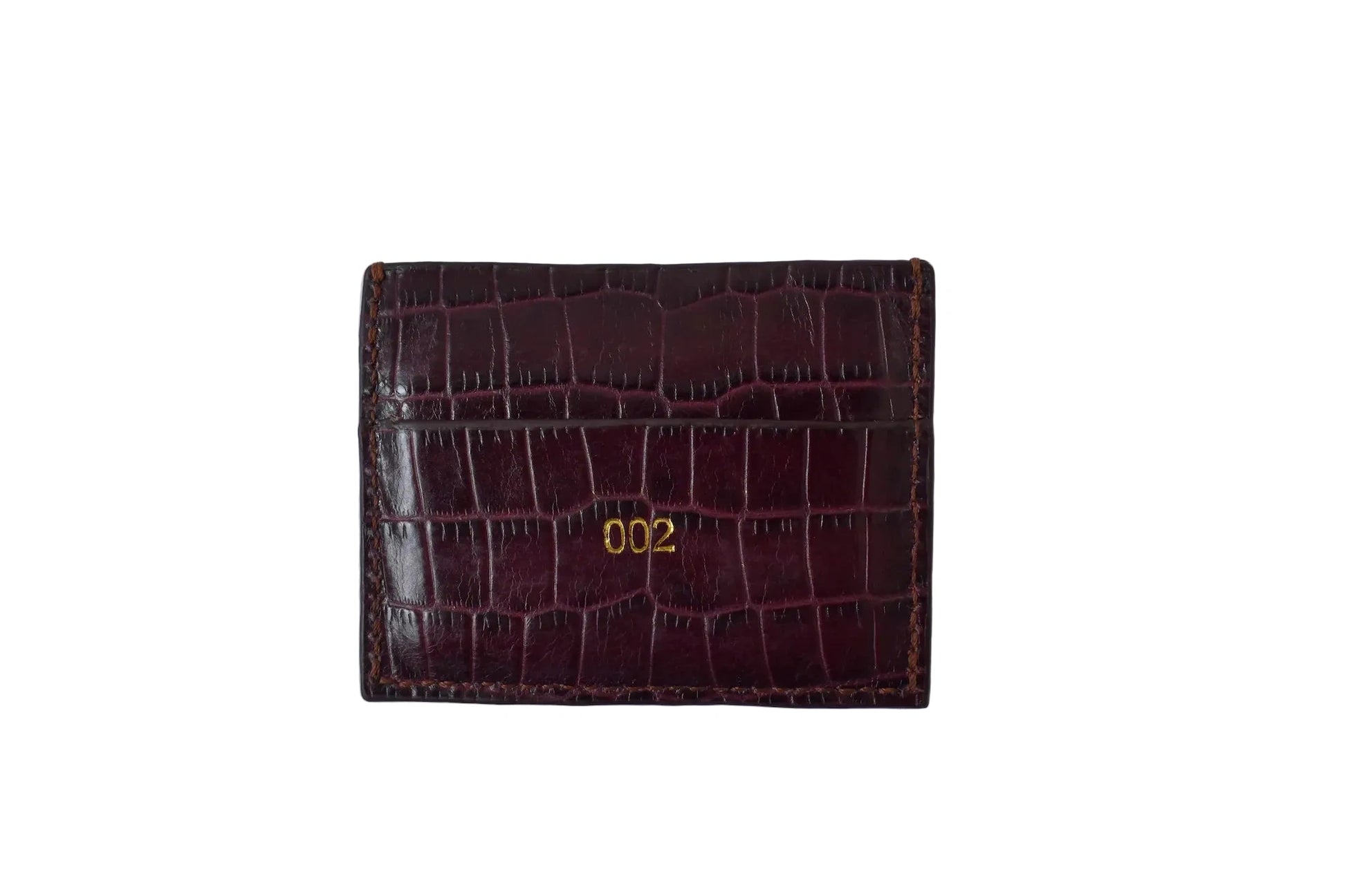 Burgundy crocodile-patterned wallet with '002' on a white background