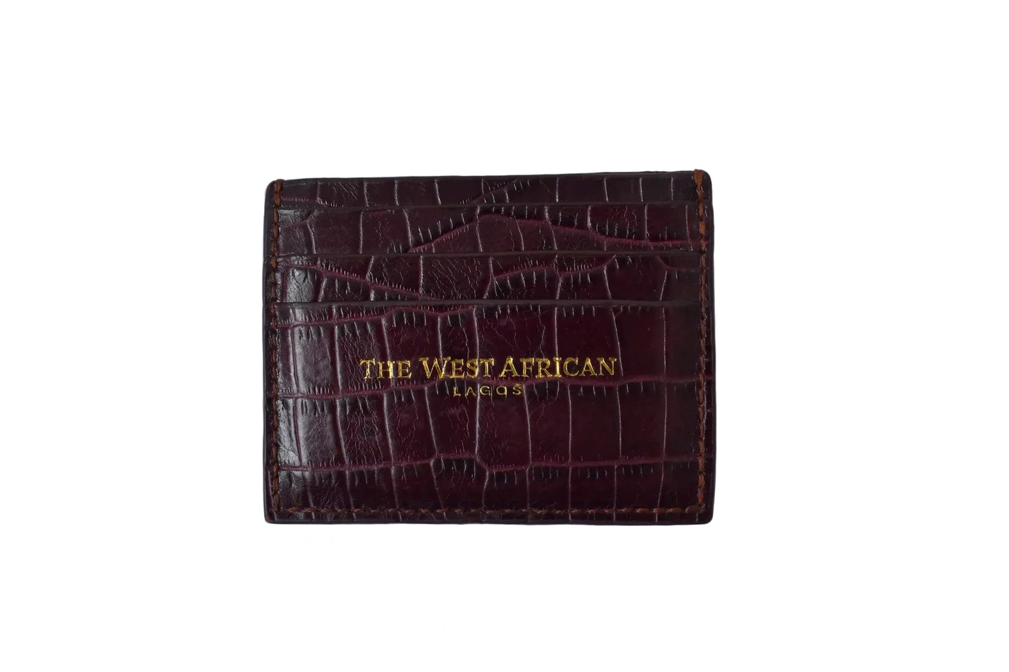 Burgundy leather cardholder with 'The West African' branding on a white background